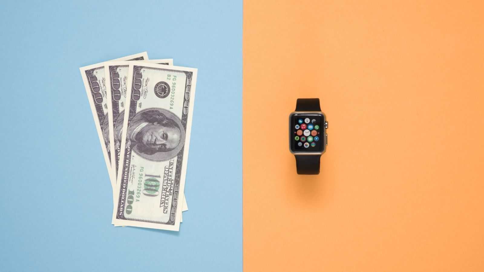 Three hundred dollar bills and a smartwatch