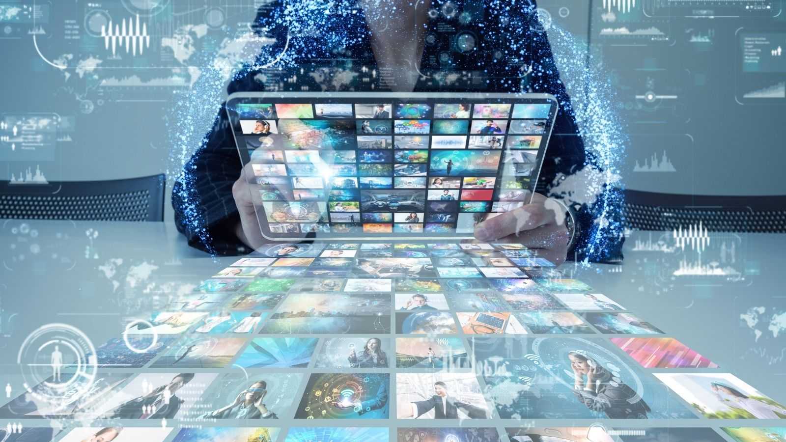A person holding a tablet with many images on it