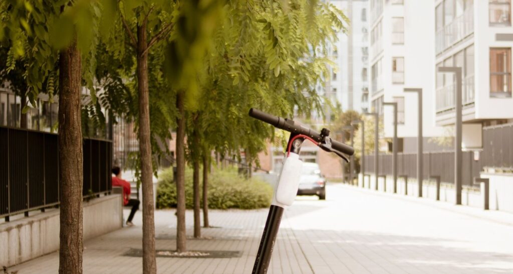 Scooter standing on sidewalks between blocks