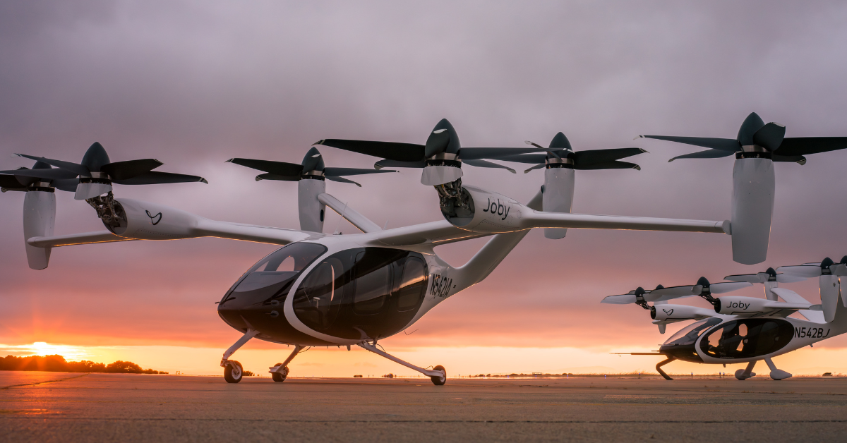 Two helicopters at sunset