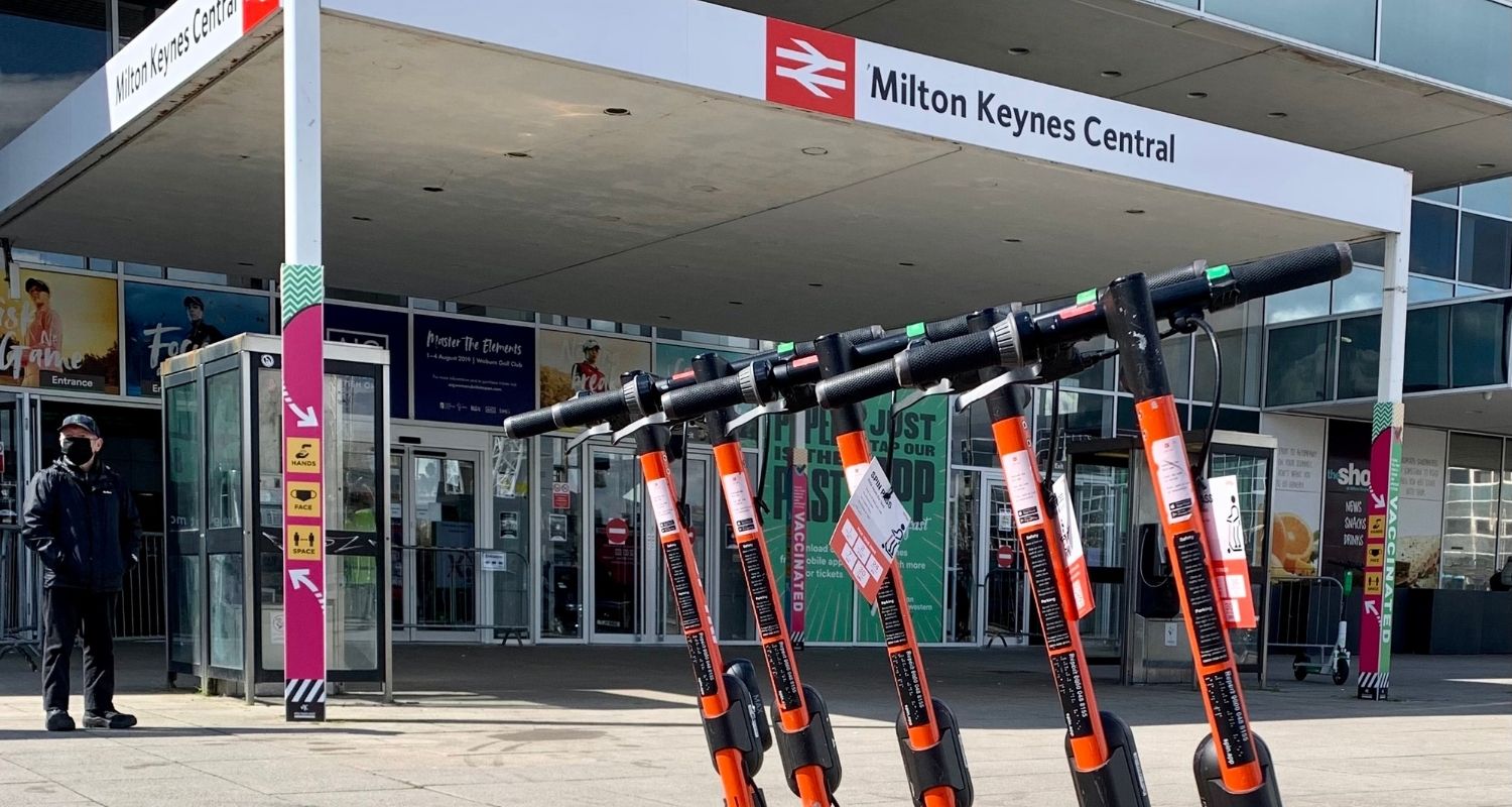 Electric scooters parked in front of the entrance to the metro station