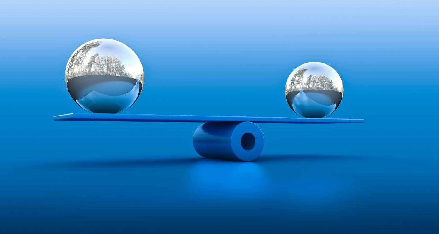 Two metal balls on a balance beam