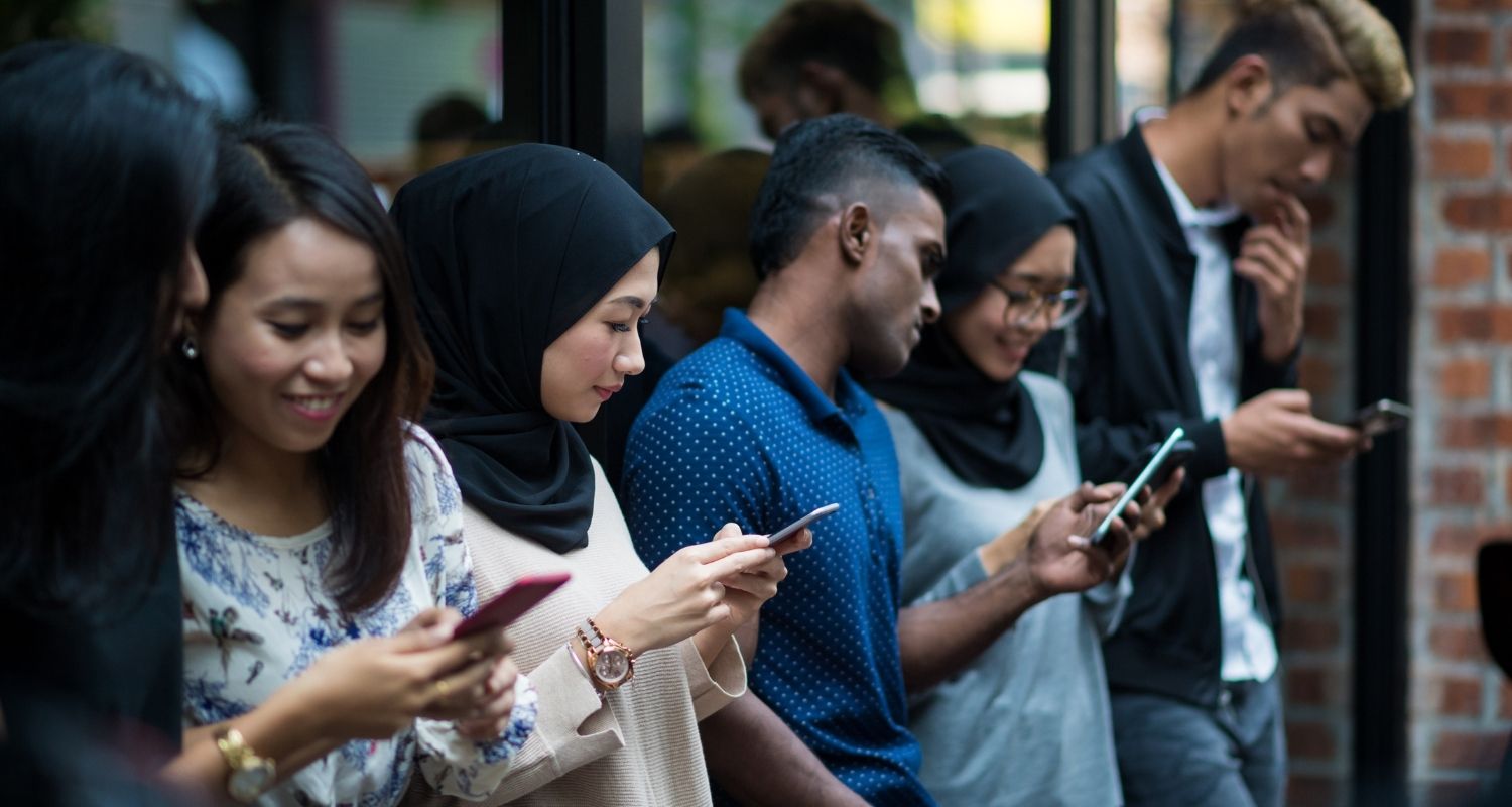 A group of young people looking at their phones