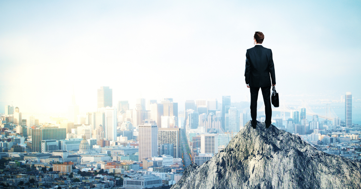 Visualization of a man in a suit standing on a rock and looking towards a modern city