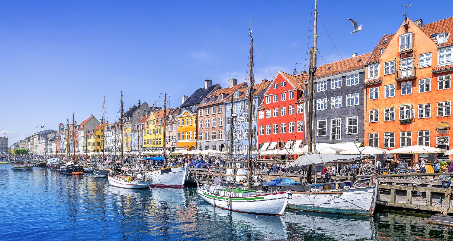 Sailboat harbor with colorful buildings in the background